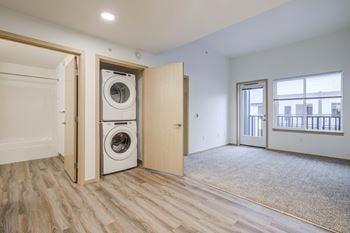 A washer and dryer in a room with a door to a laundry room